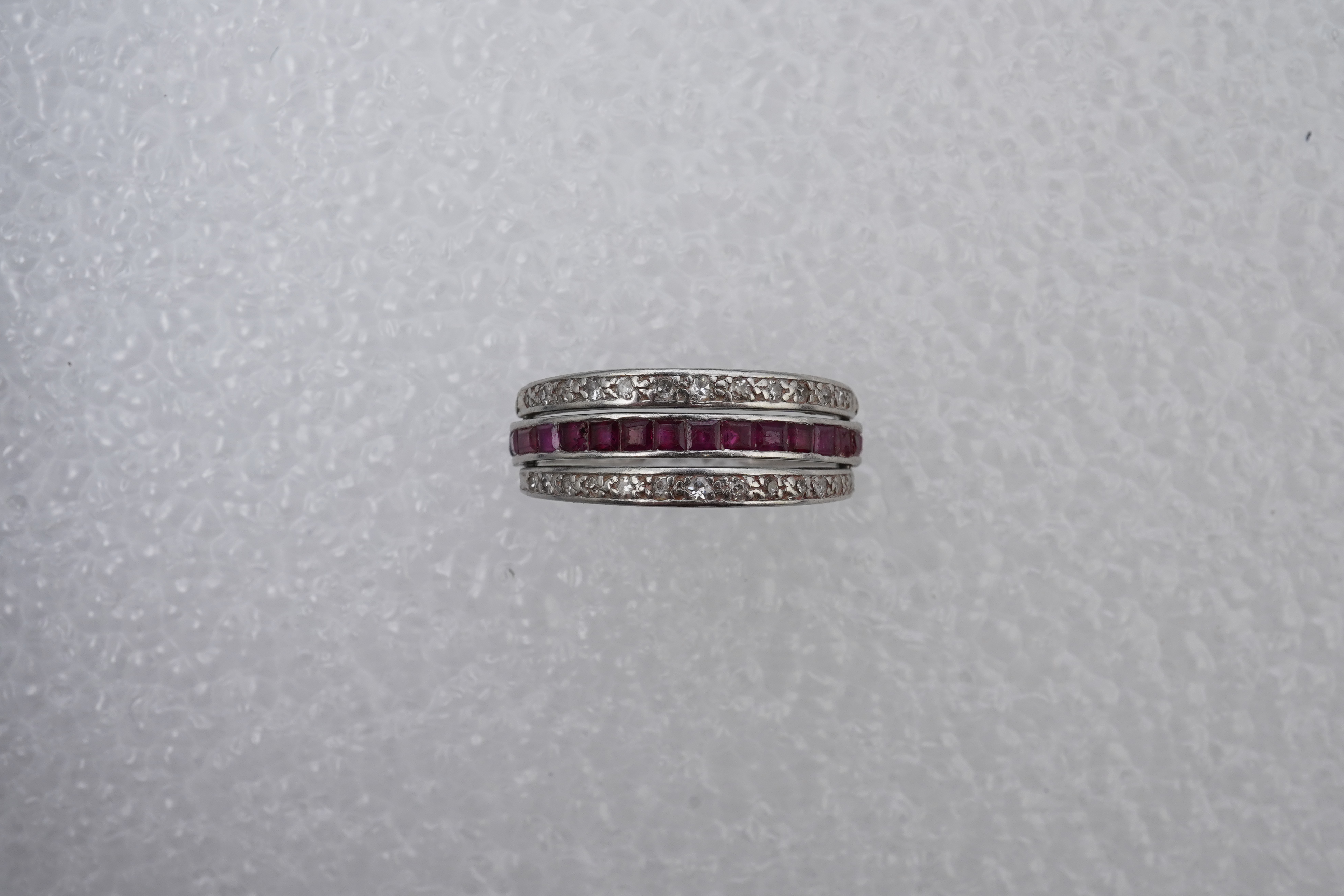 A ruby, sapphire and diamond 'Day and Night' ring, mid 20th century